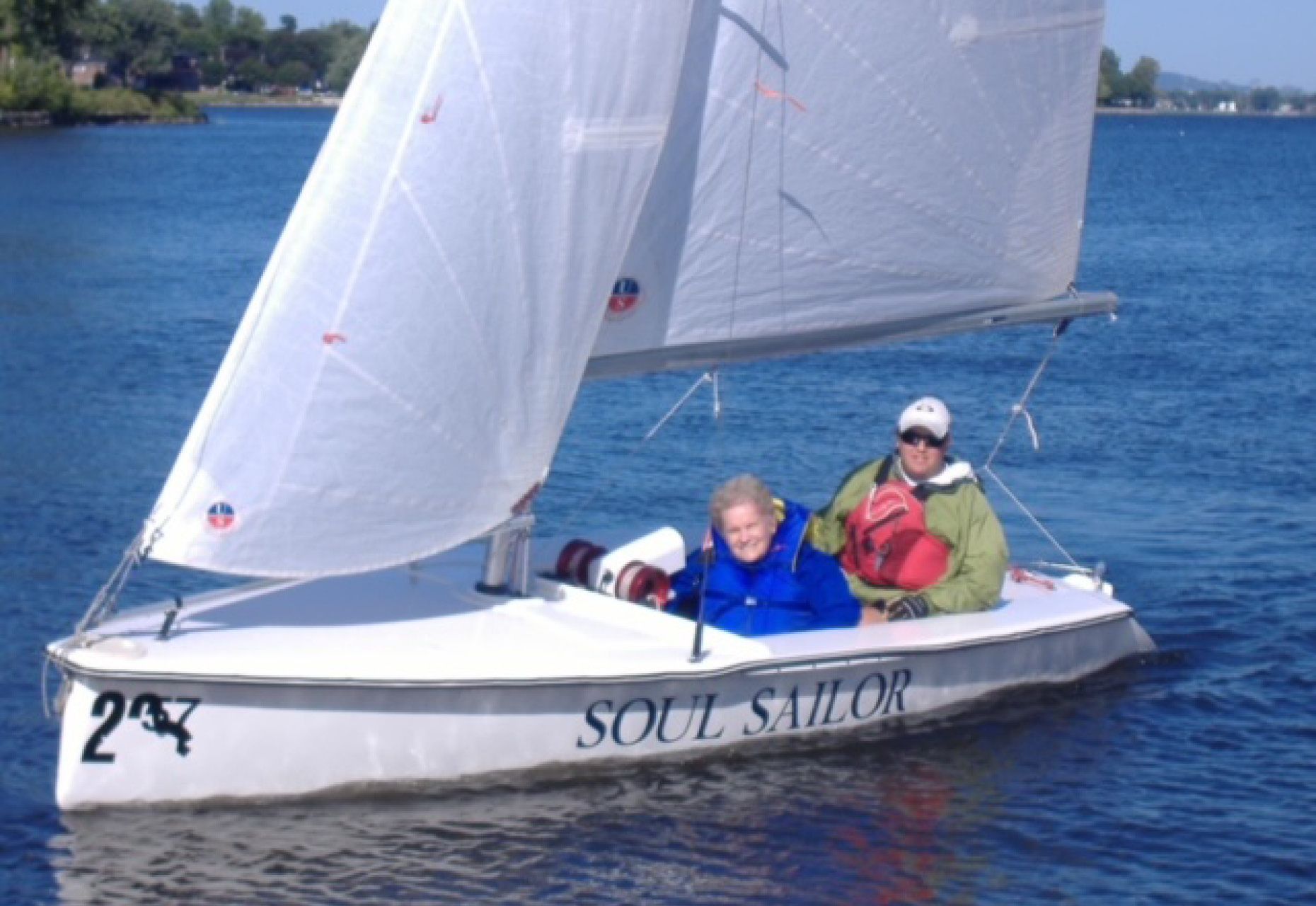 Judy Winship in a Martin 16 sailboat with a sailing companion