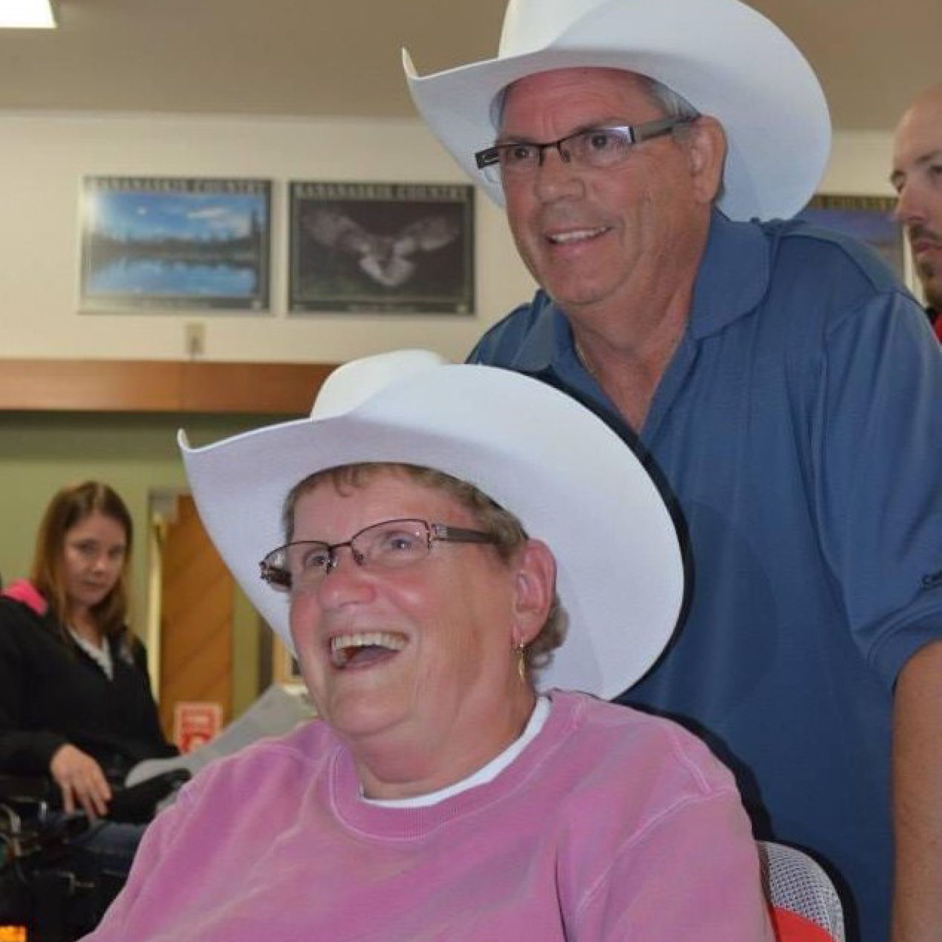 Headshots of Judy Winship and Tom Webb wearing cowboy hats