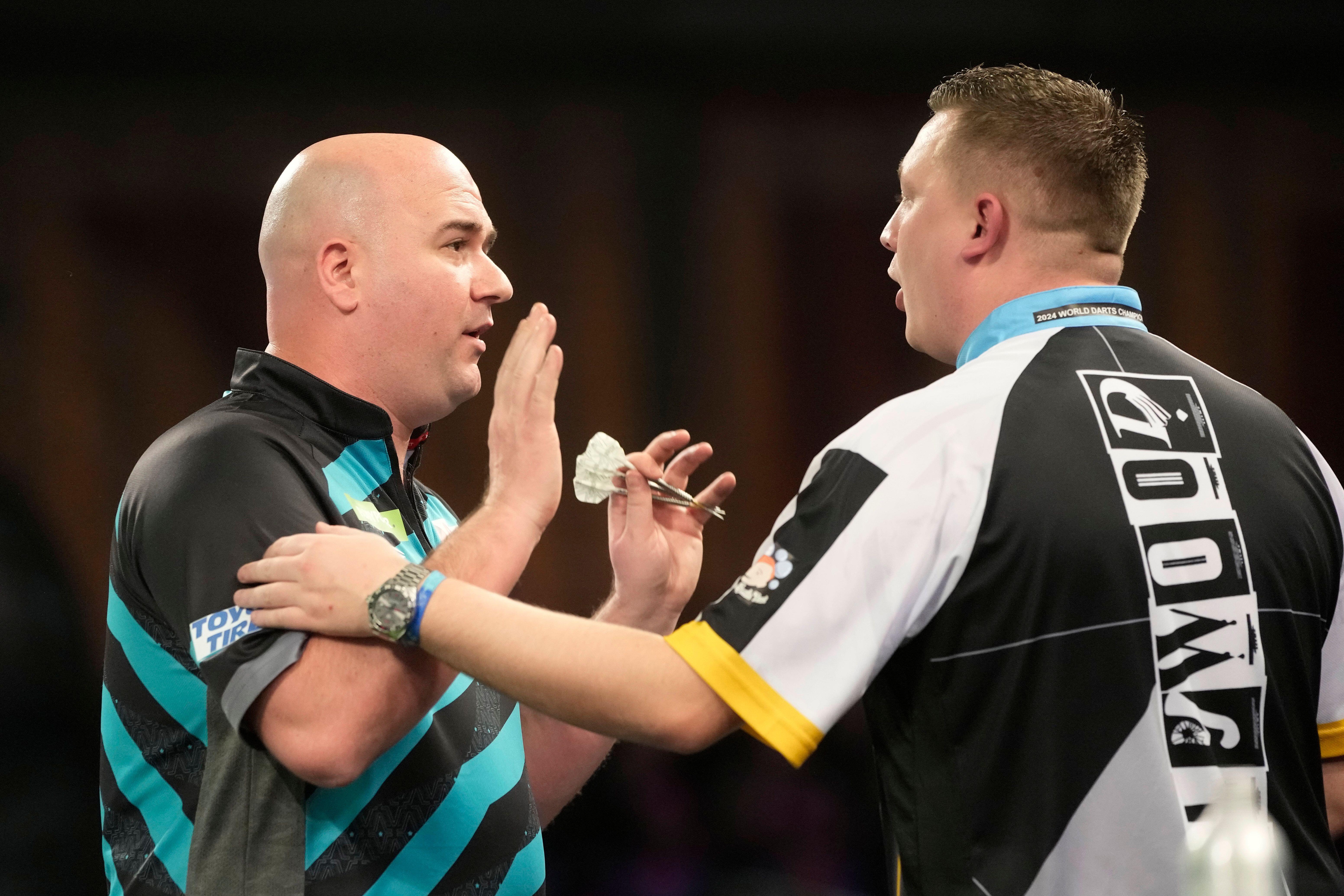 Chris Dobey and Rob Cross played out an all-time classic quarter-final last year (Alamy)